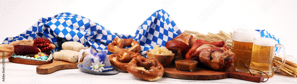 Traditional German cuisine, Schweinshaxe roasted ham hock. Beer, pretzels and various Bavarian specialties. Oktoberfest background - obrazy, fototapety, plakaty 