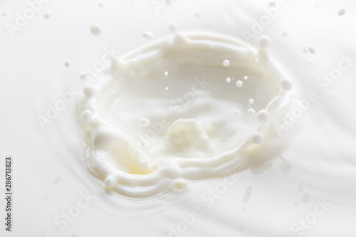 splash on the surface of white milk on a white background