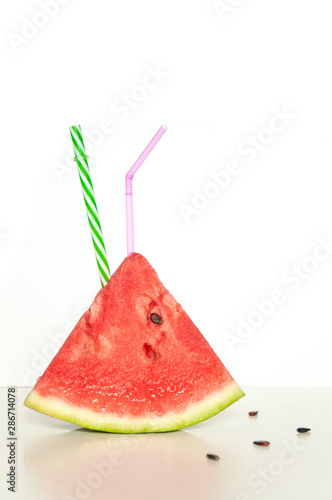 Slices of juicy ripe red watermelon on a white background. Fresh watermelon juice. Cocktails and soft drinks with watermelon.