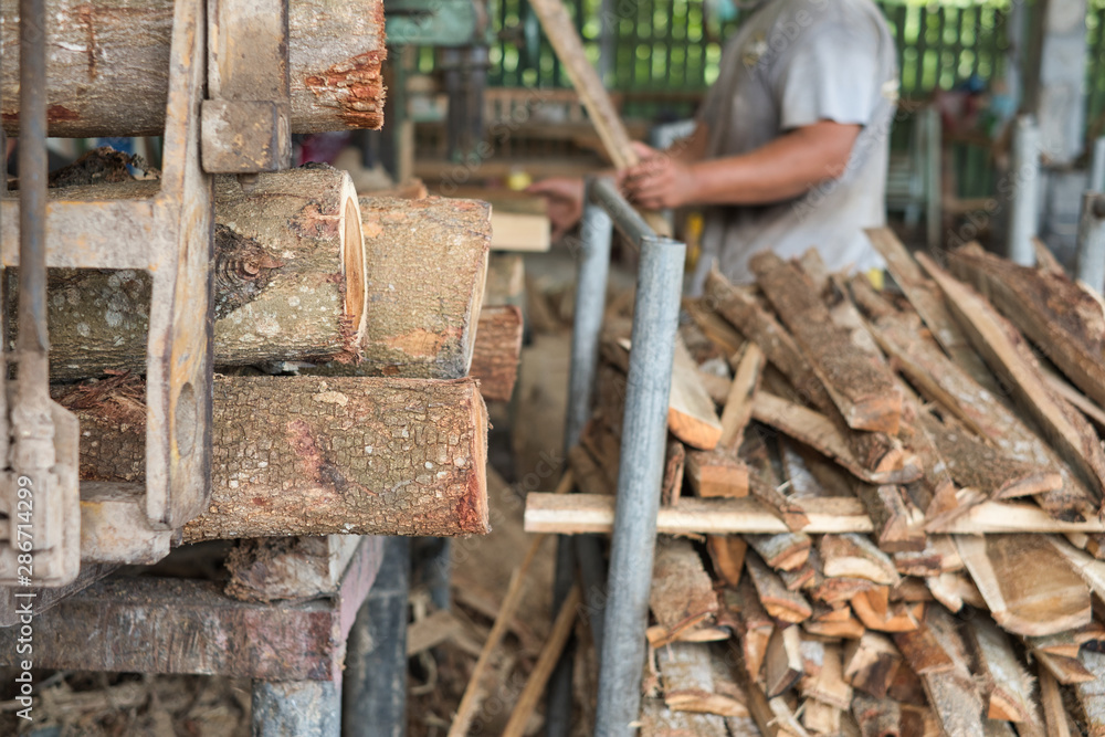 Pile of logs and woods in wood factory waiting for further cutting process. Pile of logs and woods in wood factory waiting for further cutting process.