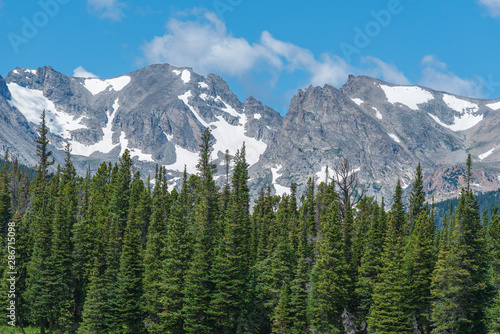 Colorado low angle landscape of forest and snow-dappled mountains at Brainard Lake Recreation Area
