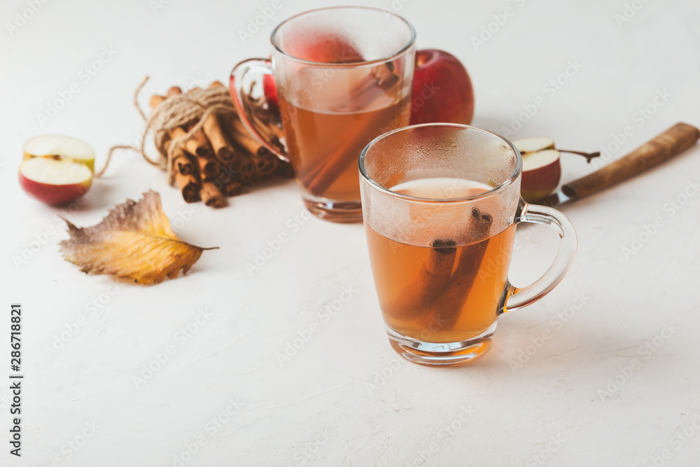 Autumn hot spicy tea glasses with cinnamon sticks Autumn hot spicy tea glasses with cinnamon sticks