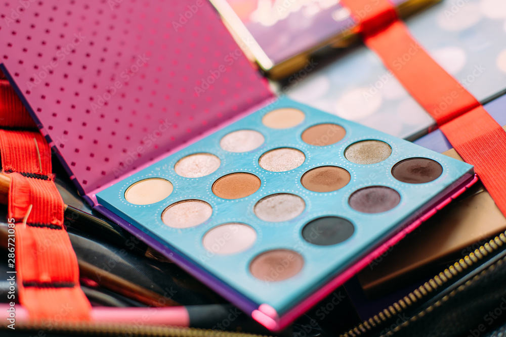 Professional cosmetics, eye shadow palette, warm brown shades. Decorative cosmetics for eye makeup, close-up. Professional cosmetics, eye shadow palette, warm brown shades. Decorative cosmetics for eye makeup, close-up.