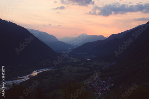 Sunset over layers of misty foggy mountains valley river