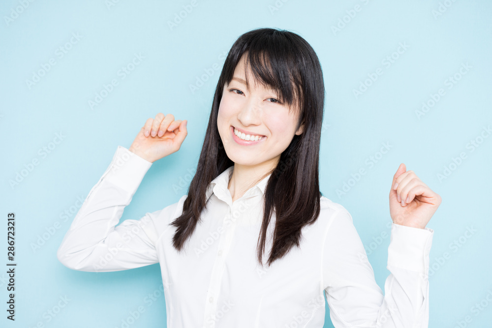 Happy business woman against light blue background Happy business woman against light blue background