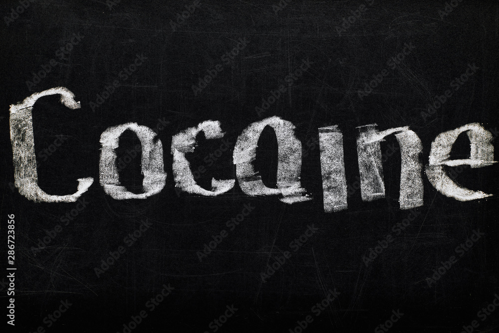 Obraz premium top view of black chalk board with lettering cocaine