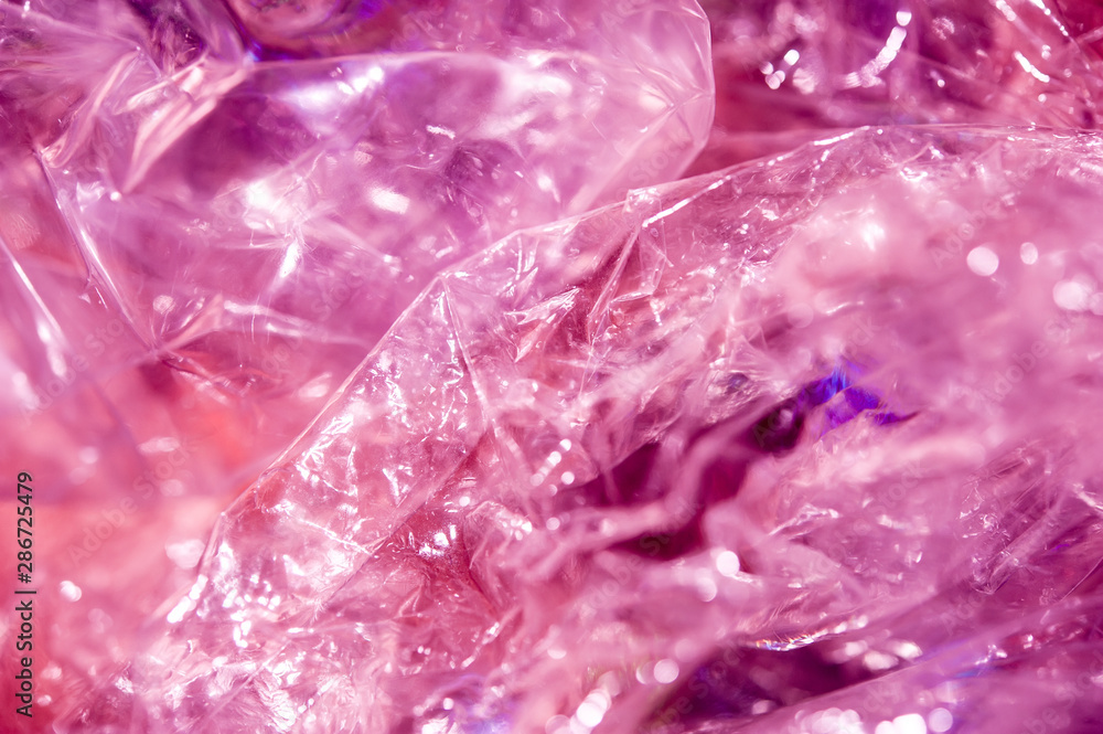 Holographic background in the style of the 80-90s. Real texture of cellophane film in bright acid colors. Holographic background in the style of the 80-90s. Real texture of cellophane film in bright acid colors.