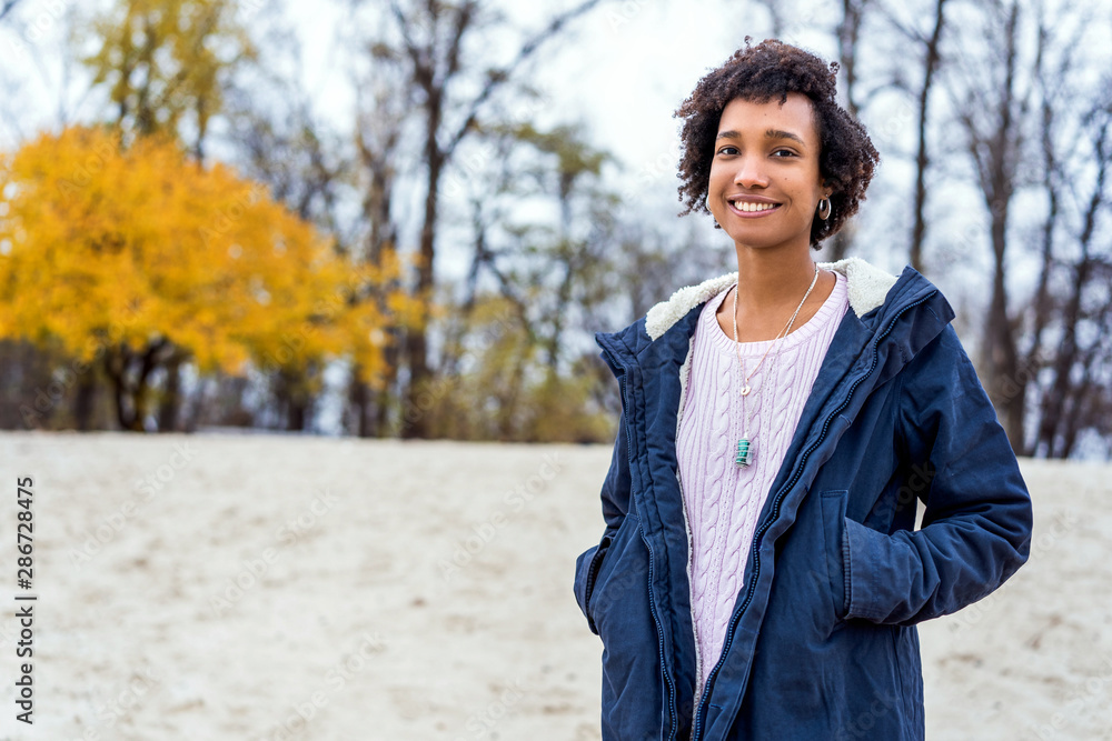 afro girl in autumn park outdoors smiling