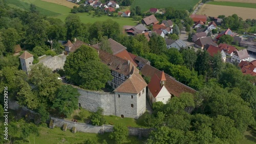 Aerial view of the castle Tannenburg in Germany on a sunny day in spring. Pan to the left above the top. photo