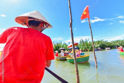 Tourists Riding on Traditional Vietnamese Bamboo Basket Boats photo