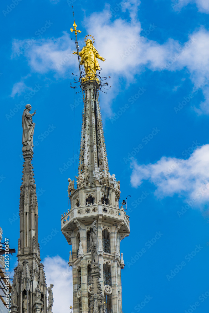 Statue of the Virgin Mary on top of Milan Cathedral (Duomo di Milano) in Italy Statue of the Virgin Mary on top of Milan Cathedral (Duomo di Milano) in Italy