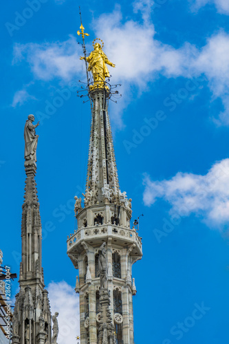 Statue of the Virgin Mary on top of Milan Cathedral (Duomo di Milano) in Italy © BGStock72
