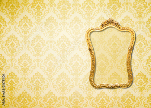 Gold frame  on the wall wallpaper thai the dark.