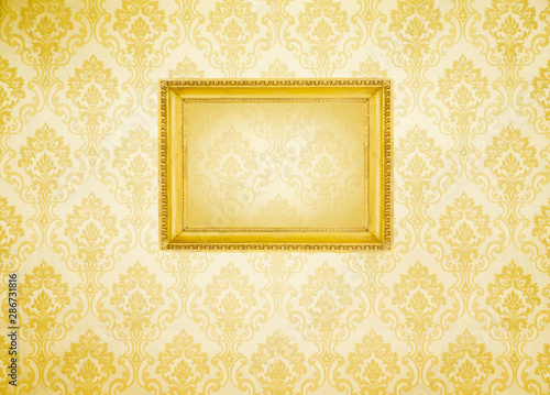 Gold frame  on the wall wallpaper thai the dark.