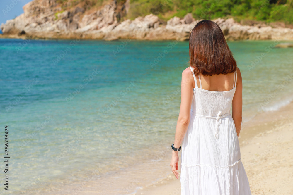 A beautiful broken heart women is alone and feel down on the beach.Valentine's concept. A beautiful broken heart women is alone and feel down on the beach.Valentine's concept.