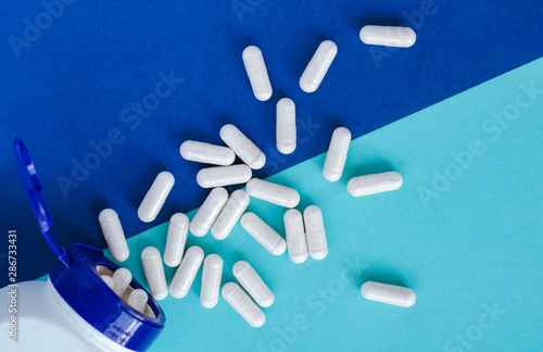 Different pharmaceutical pills and capsules from a jar.