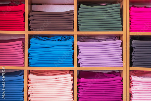 Wardrobe with different colors clothes.