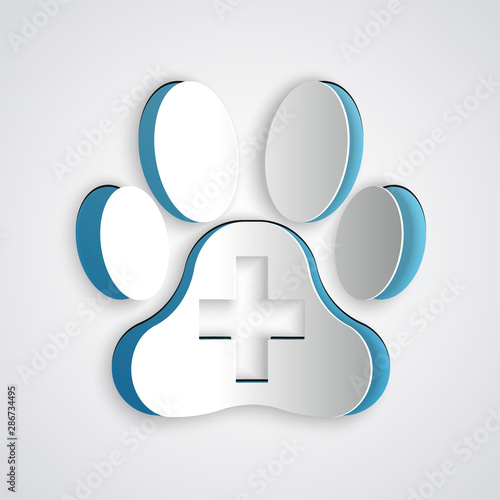Paper cut Veterinary clinic symbol icon isolated on grey background. Cross hospital sign. A stylized paw print dog or cat. Pet First Aid sign. Paper art style. Vector Illustration