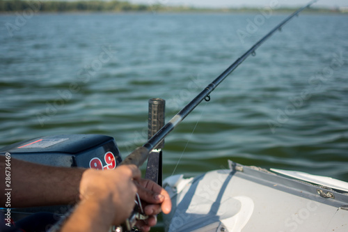 spinning reel in hands on a boat