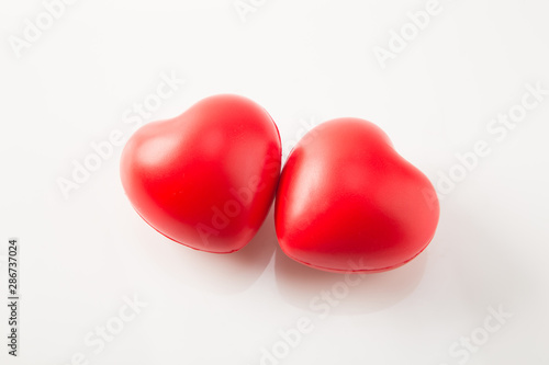 Two red heart shape isolated on white background © byjeng