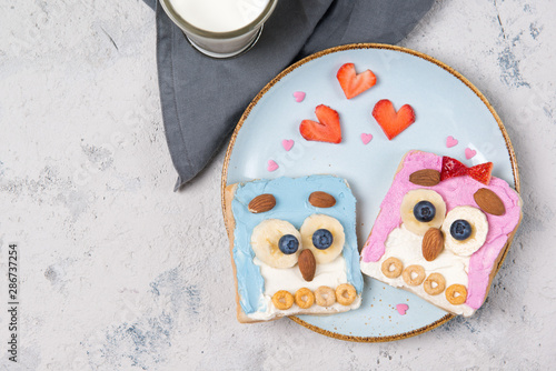Owl toasts with cream cheese, fruits and cereals, food for kids idea, top view