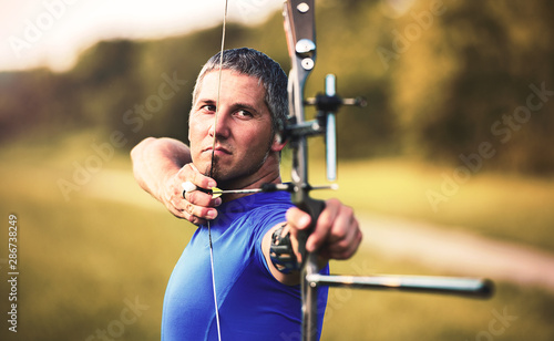 Fényképezés Archer. Sportsman practicing archery. Sport, recreation concept