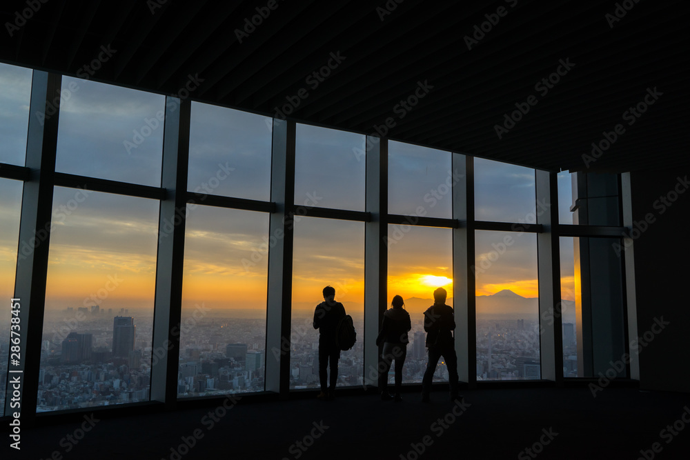 Silhouette of tourism looking a mtfuji from building in tokyo Silhouette of tourism looking a mtfuji from building in tokyo