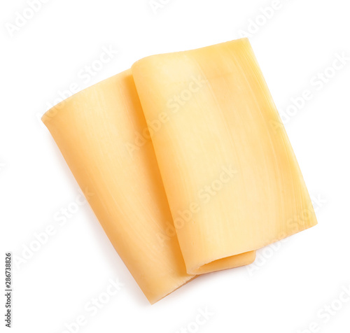Slices of tasty cheese on white background, top view