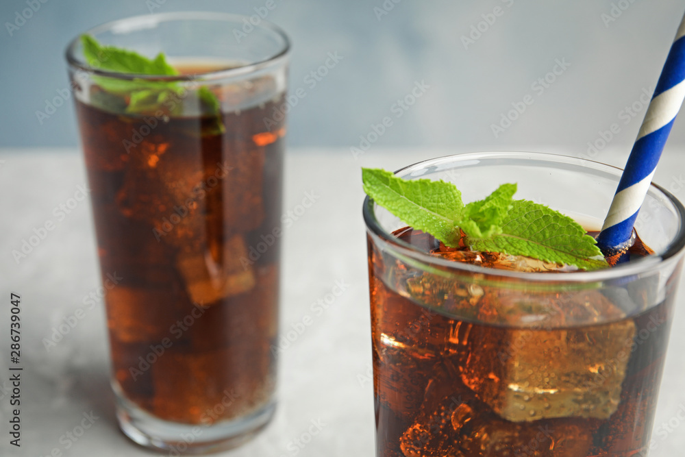 Refreshing soda drinks with ice cubes on table, closeup. Space for text Refreshing soda drinks with ice cubes on table, closeup. Space for text
