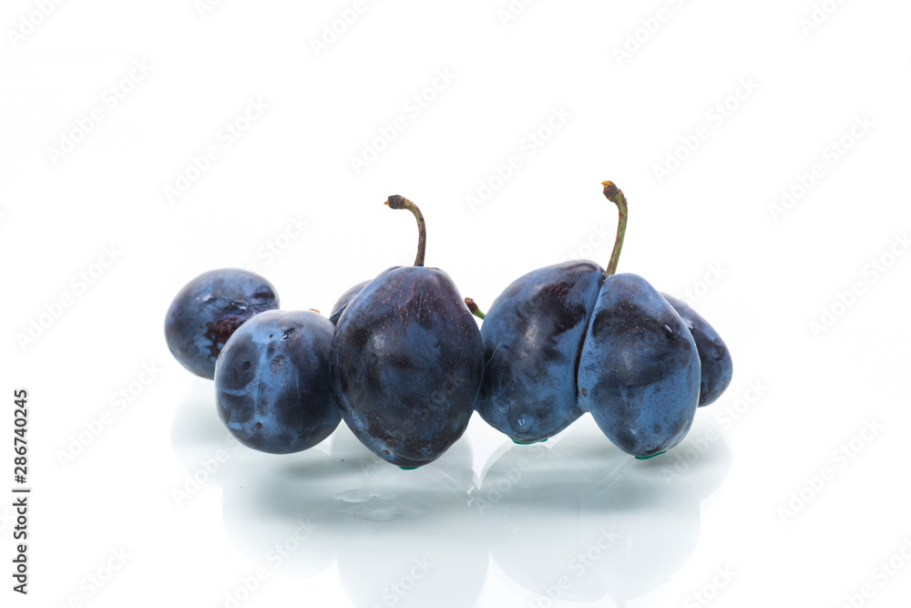 A lot of ripe organic plums isolated on a white