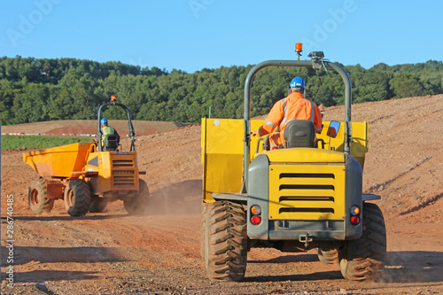 Fotografía Dump trucks on a road construction site