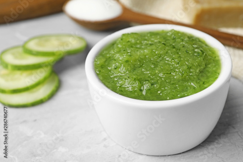 Handmade face mask and ingredients on grey table