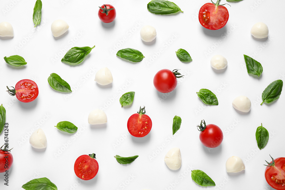 Flat lay composition with fresh ingredients for pizza on white background Flat lay composition with fresh ingredients for pizza on white background