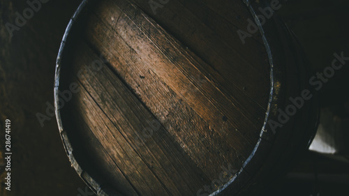 Fotografie, Tablou Whiskey barrel closeup in dark interior