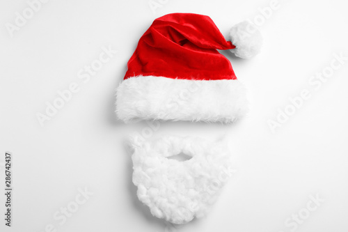 Santa Claus hat with beard on white background, top view
