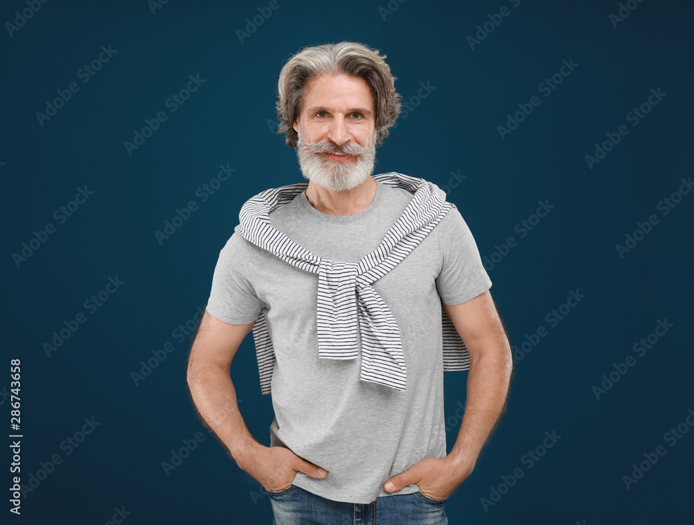 Portrait of handsome mature man on blue background Portrait of handsome mature man on blue background