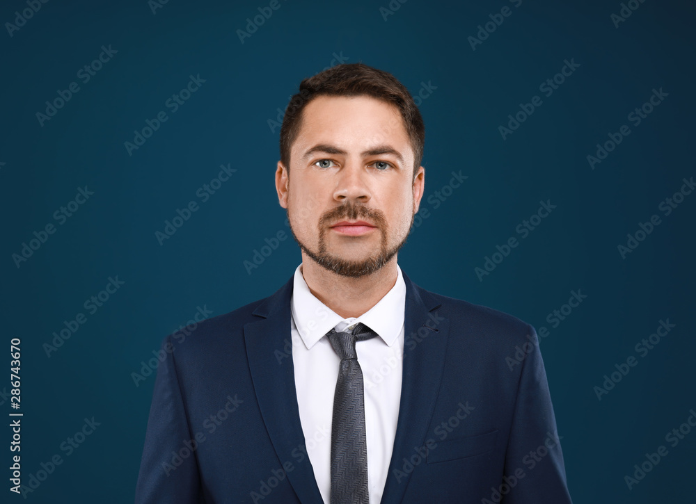 Portrait of handsome man in suit on blue background Portrait of handsome man in suit on blue background