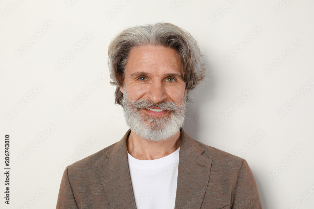 Portrait of handsome mature man on light background Portrait of handsome mature man on light background