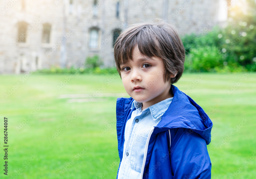 Portrait of cute little looking at camera standing in the castle, Preschool kid playing outdoor next to museum, Child learn and play concept Portrait of cute little looking at camera standing in the castle, Preschool kid playing outdoor next to museum, Child learn and play concept