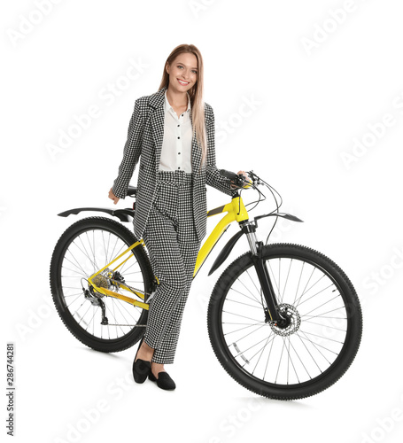 Young businesswoman with bicycle on white background