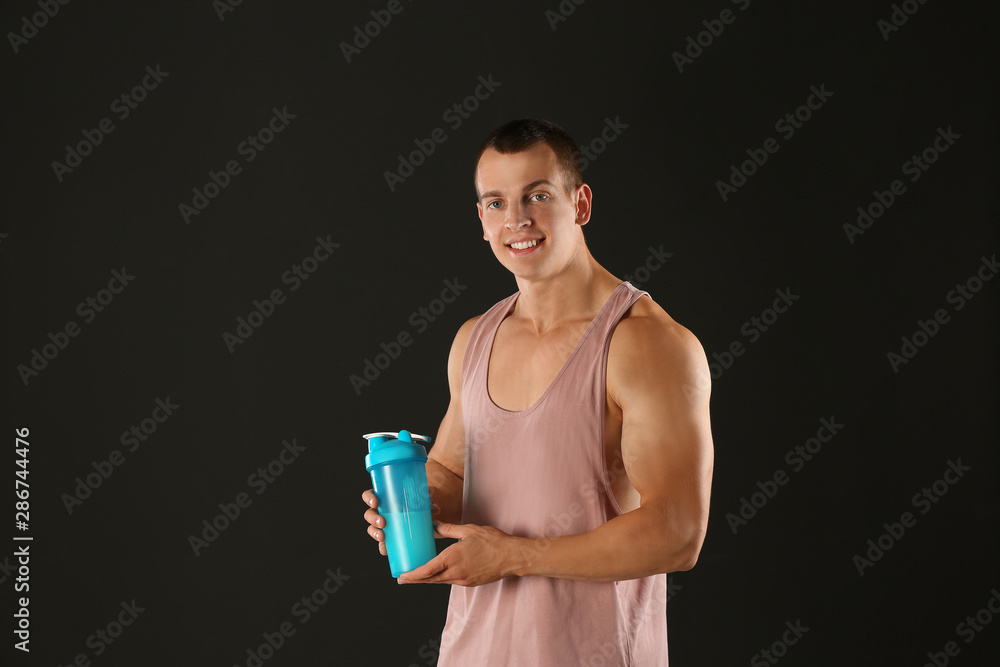 Athletic young man with protein shake on black background Athletic young man with protein shake on black background