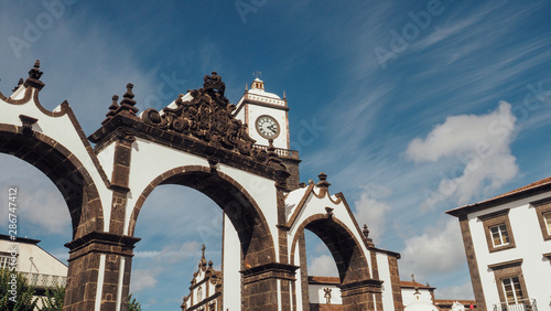 Portas da Cidade to the village of Ponta Delgada in Azores, Portugal. Entrance gates and the clock tower of Saint Sabastian church. photo