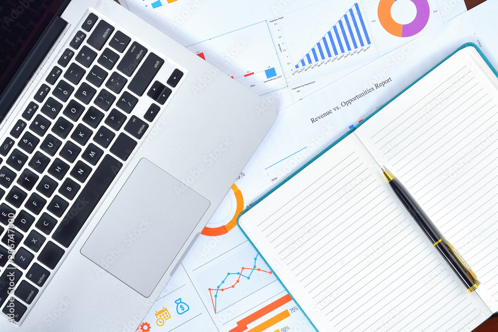 Business and Finances Concepts. Laptop, Notebook with graph and pen