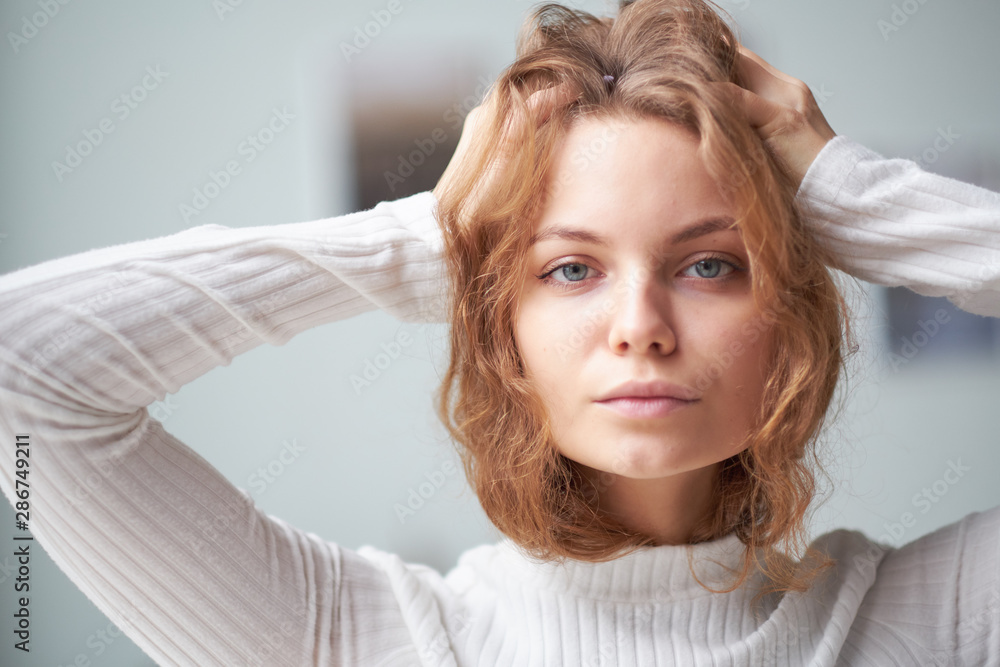 portrait of a beautiful curly girl. the mysterious face of a woman at the window. portrait of a beautiful curly girl. the mysterious face of a woman at the window.