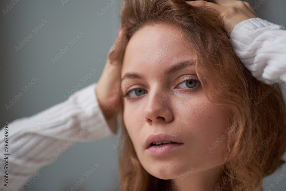 portrait of a beautiful curly girl. the mysterious face of a woman at the window. portrait of a beautiful curly girl. the mysterious face of a woman at the window.