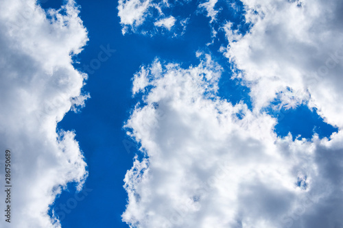 Clouds and blue sky. Passage between clouds. The border between the two cyclone. Heavenly landscape.