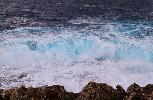 Huge waves crash on cloudy day. Kemmuna island