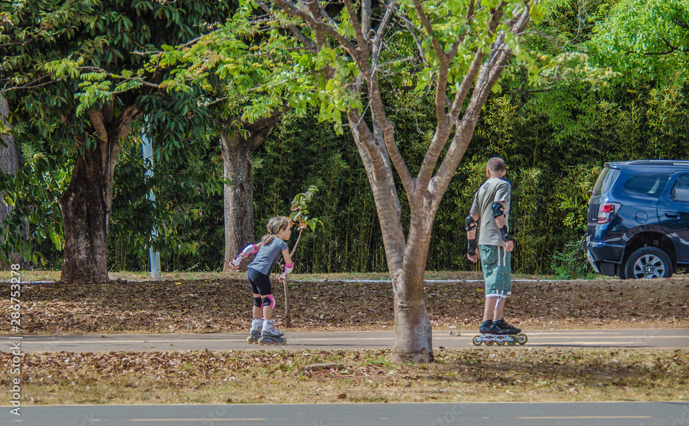 A beautiful view of people walking with rollerblades in Brasilia park, Brazil A beautiful view of people walking with rollerblades in Brasilia park, Brazil