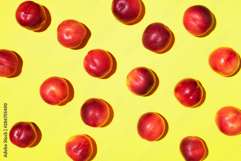 Nectarines pattern on yellow background. Frame made of fresh fruits. Flat lay, top view, copy space. Vegan and vegetarian diet Nectarines pattern on yellow background. Frame made of fresh fruits. Flat lay, top view, copy space. Vegan and vegetarian diet