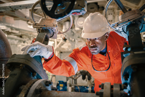Offshore vessel worker handling pipelines
